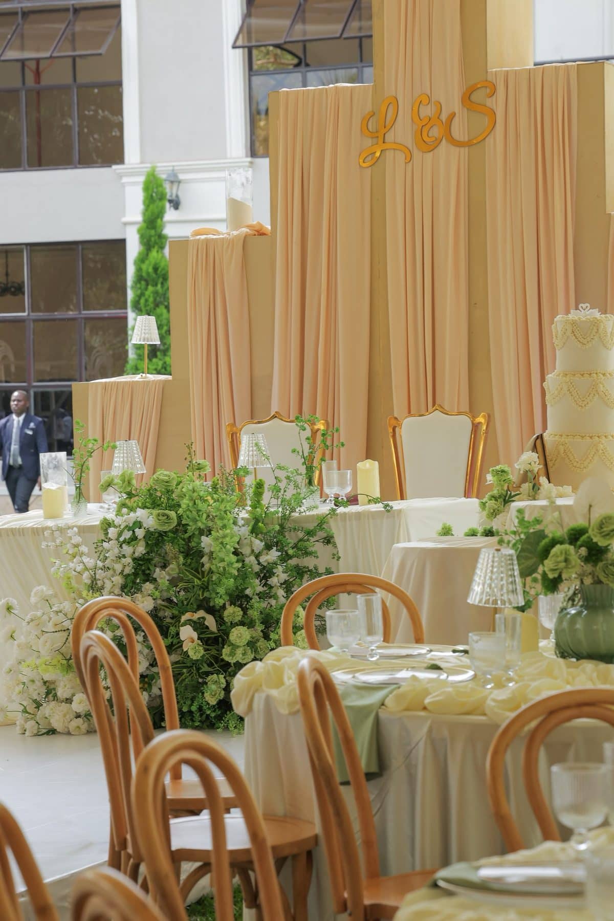 The cake table, framed in greenery